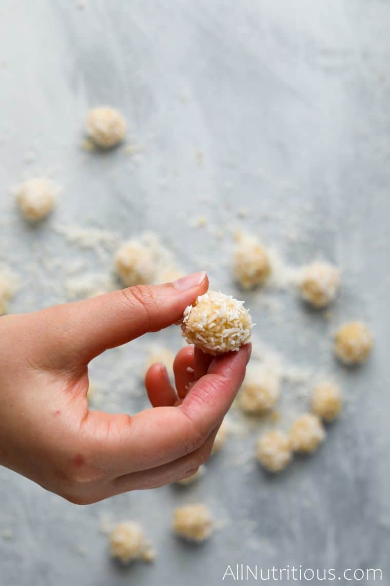 hand with coconut protein ball