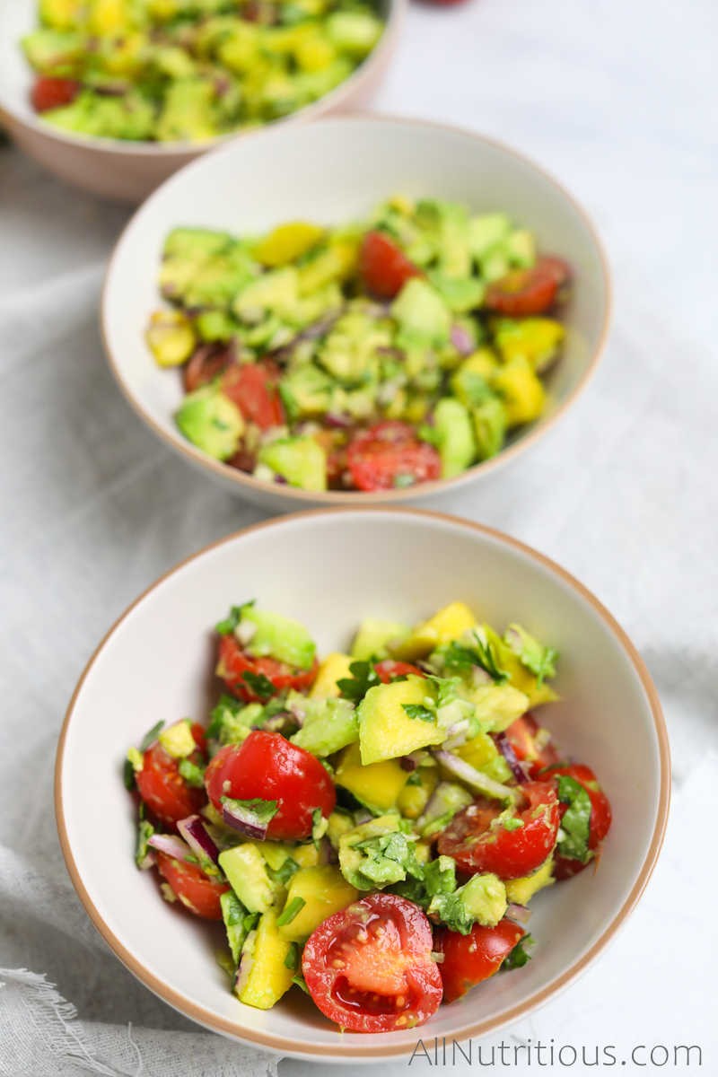 three bowls of mango salad with tomatoes