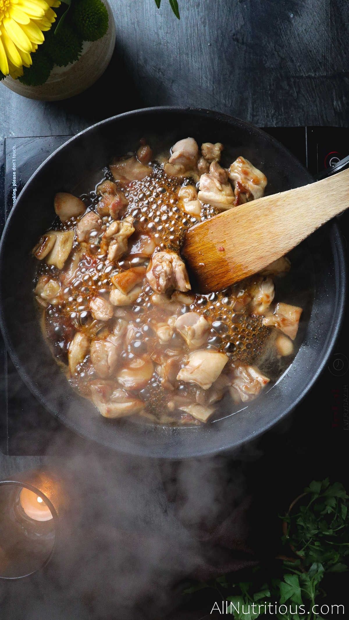 chicken in pan with sauce