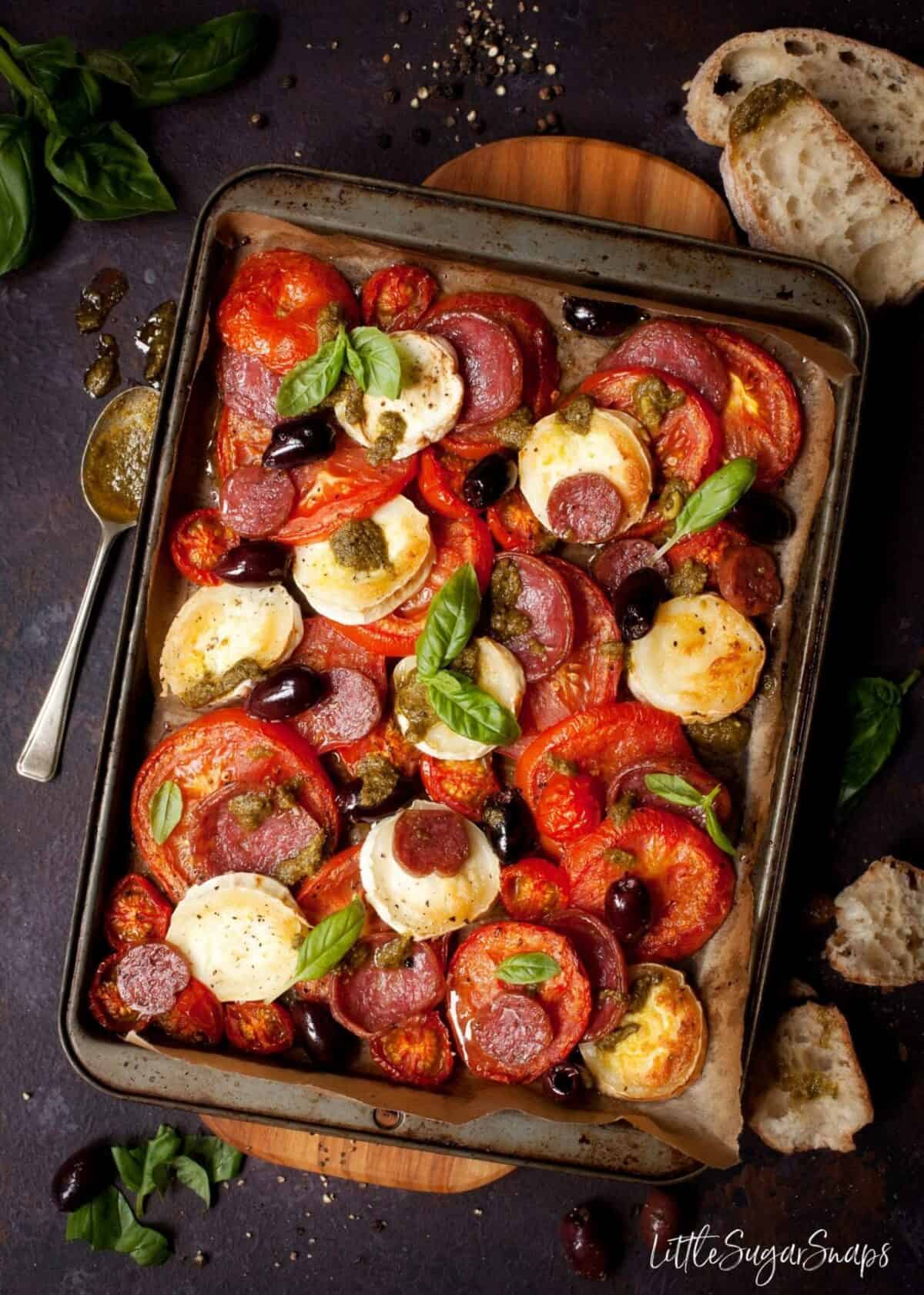 Baked Tomato and Goats Cheese with Salami, Olives, and Pesto