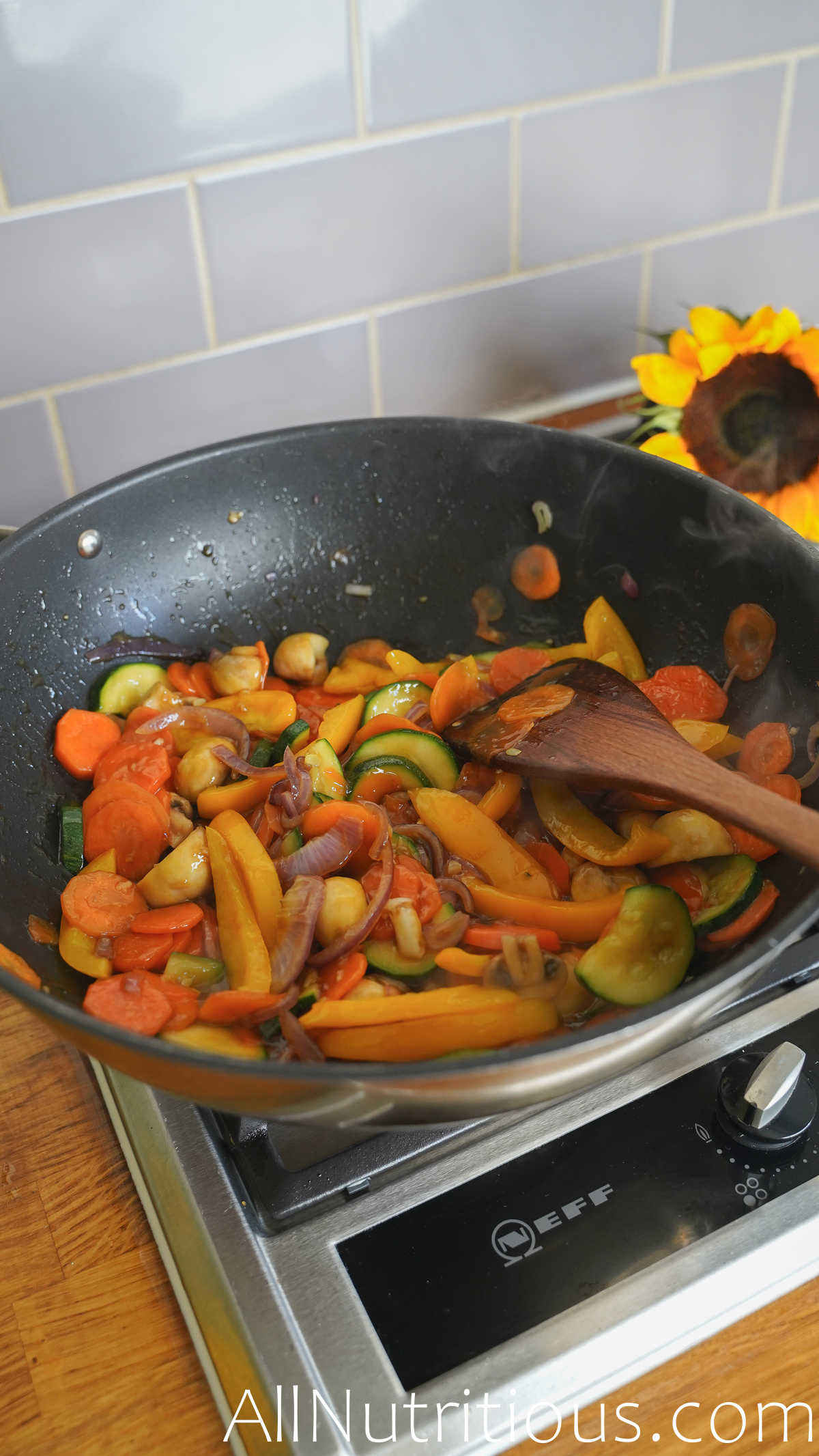 adding sauce to veggies in pan