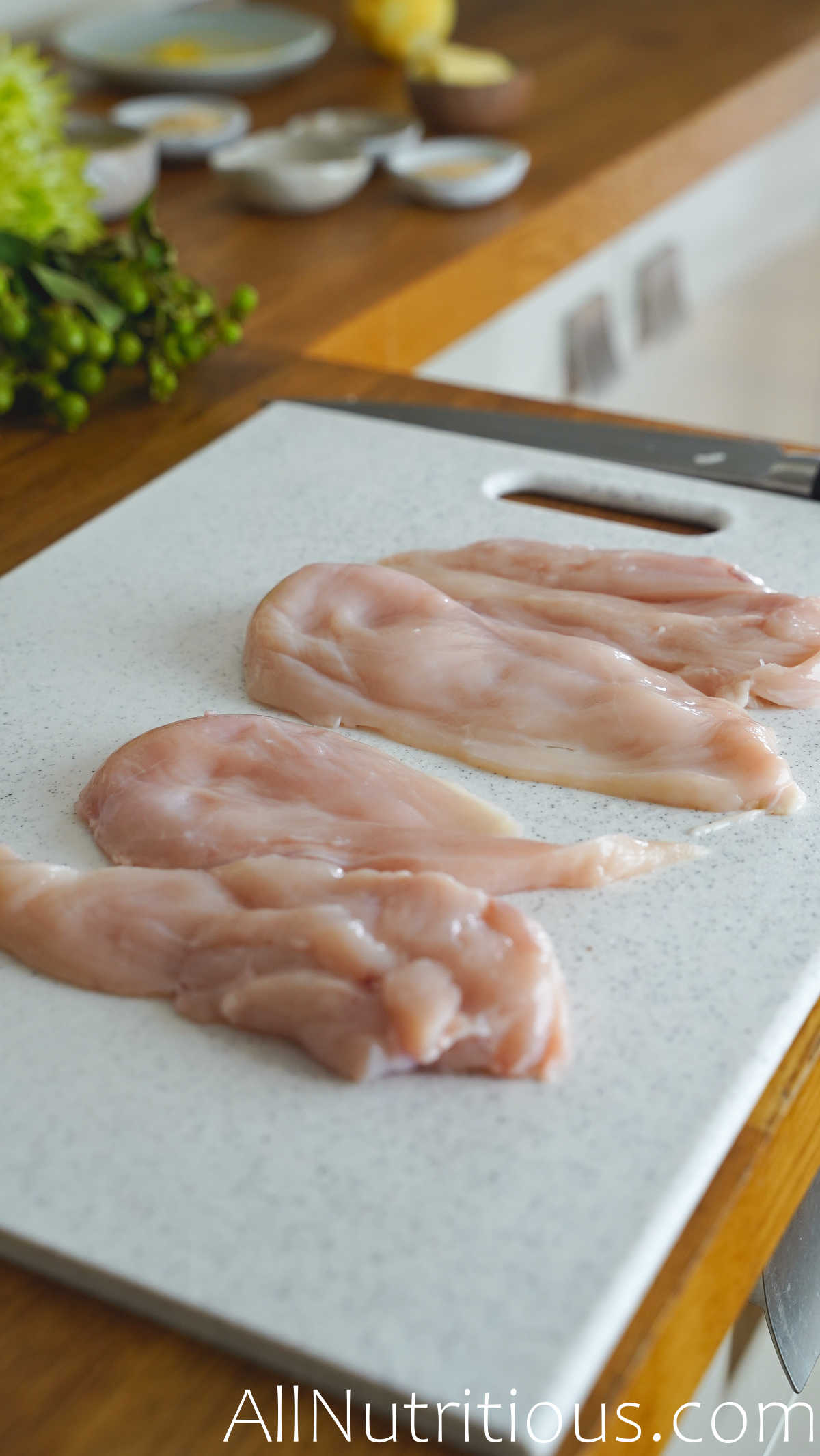 chicken breasts on chopping board