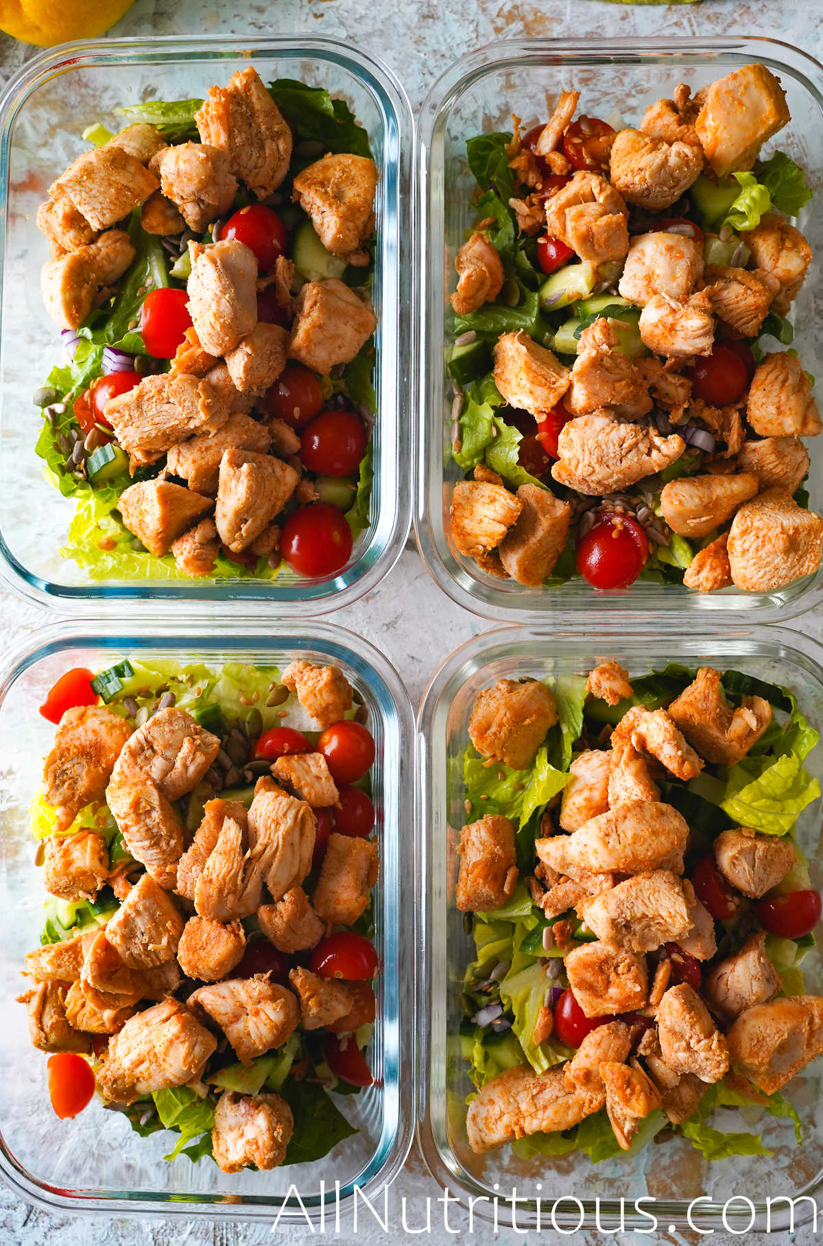 chicken and salad in meal prep bowls
